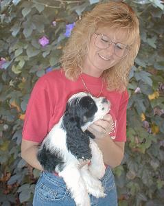 Sheena holding a parti puppy